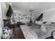 Comfortable living room with a gray sectional sofa, fireplace, hardwood floors, and decorative wall art at 9628 Gull Lake Dr, Indianapolis, IN 46239