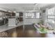 Open-concept kitchen and living space with hardwood floors, neutral paint, and natural light throughout the area at 9628 Gull Lake Dr, Indianapolis, IN 46239