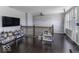 Bright loft featuring hardwood floors, a large TV, and ample shelving for books and storage at 9628 Gull Lake Dr, Indianapolis, IN 46239