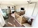 Upstairs loft space featuring hardwood floors, a ceiling fan, a view of the staircase, and access to multiple rooms at 9628 Gull Lake Dr, Indianapolis, IN 46239