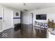 Open loft area with hardwood floors, a TV, and multiple doors leading to other rooms at 9628 Gull Lake Dr, Indianapolis, IN 46239
