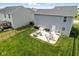 A spacious backyard includes a patio with an outdoor dining set, furniture, and a fenced perimeter at 9855 Oakmont E E Dr, Pendleton, IN 46064