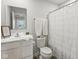 Clean bathroom featuring a white vanity, toilet, shower with curtain, and neutral decor at 9855 Oakmont E E Dr, Pendleton, IN 46064