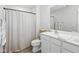 Bathroom boasting a shower with gray curtain, modern cabinets, a large mirror, and a double vanity at 9855 Oakmont E E Dr, Pendleton, IN 46064