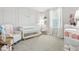 Lovely Bedroom with pale pink walls, white trim, white crib, accent chair, and plush carpet at 9855 Oakmont E E Dr, Pendleton, IN 46064