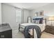 Bedroom boasts a comfortable bed with stylish bedding, soft carpet, and natural light from window at 9855 Oakmont E E Dr, Pendleton, IN 46064