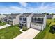 Charming two-story home showcasing a well-manicured lawn and a double garage at 9855 Oakmont E E Dr, Pendleton, IN 46064
