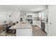 Bright kitchen features white cabinetry, stainless appliances, subway tile backsplash, and granite island with bar stool seating at 9855 Oakmont E E Dr, Pendleton, IN 46064