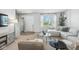 Sunlit living area featuring modern furnishings and décor, with a seamless transition to the front entry at 9855 Oakmont E E Dr, Pendleton, IN 46064