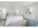 Calm and relaxing main bedroom features soft gray walls, soft carpet, an upholstered headboard, and a chest of drawers at 9855 Oakmont E E Dr, Pendleton, IN 46064