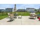 Large concrete patio area with outdoor seating and dining, perfect for entertaining and relaxation at 9855 Oakmont E E Dr, Pendleton, IN 46064