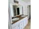Bathroom with double sinks, vanity, and a large mirror at 9987 Rainbow Falls Ln, Fishers, IN 46037
