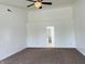 Bedroom featuring neutral carpet, high ceilings, and open doorway to bathroom at 9987 Rainbow Falls Ln, Fishers, IN 46037