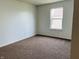 This bedroom features carpet, neutral walls, and a large window for natural light at 9987 Rainbow Falls Ln, Fishers, IN 46037