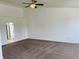 Large bedroom with neutral carpet, high ceilings, and open doorway to bathroom at 9987 Rainbow Falls Ln, Fishers, IN 46037
