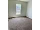 Bright bedroom with neutral carpet and a window offering natural light at 9987 Rainbow Falls Ln, Fishers, IN 46037