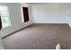Spacious bedroom featuring neutral carpet, white walls, and natural light at 9987 Rainbow Falls Ln, Fishers, IN 46037