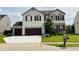 Charming two-story home with a two-car garage and a well-maintained front lawn at 9987 Rainbow Falls Ln, Fishers, IN 46037