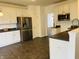 Spacious kitchen with stainless steel refrigerator and ample counter space at 9987 Rainbow Falls Ln, Fishers, IN 46037
