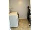 Laundry room featuring a modern washing machine, storage shelves, and tiled flooring at 9987 Rainbow Falls Ln, Fishers, IN 46037