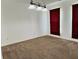 Bright living room with neutral carpet, white walls, and modern chandelier lighting at 9987 Rainbow Falls Ln, Fishers, IN 46037