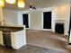 Open living space with a seamless transition from kitchen to carpeted living room at 9987 Rainbow Falls Ln, Fishers, IN 46037