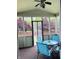 Screened in porch includes matching chairs and table overlooking the backyard at 9987 Rainbow Falls Ln, Fishers, IN 46037