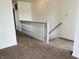Bright, neutral staircase with carpet and painted white banister at 9987 Rainbow Falls Ln, Fishers, IN 46037