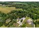 Bird's-eye view showcases this home's location near verdant fields and a surrounding canopy of trees in a rural setting at 10519 N Antioch Rd, Mooresville, IN 46158