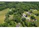 Aerial view of a neighborhood with various architectural home styles, surrounded by lush greenery and open fields at 10519 N Antioch Rd, Mooresville, IN 46158