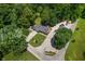 Aerial view of a home boasting a spacious driveway, well-maintained lawn, and proximity to lush greenery at 10519 N Antioch Rd, Mooresville, IN 46158
