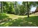 Expansive green backyard with mature trees and a gentle slope, perfect for recreation and relaxation at 10519 N Antioch Rd, Mooresville, IN 46158