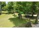 Lush backyard featuring mature trees and a shady dog run at 10519 N Antioch Rd, Mooresville, IN 46158