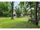 Private backyard with mature trees, stairs, grassy area, and a view of the house at 10519 N Antioch Rd, Mooresville, IN 46158