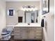 Bright bathroom with a gray vanity, neutral walls, and unique decorative touches at 10519 N Antioch Rd, Mooresville, IN 46158