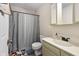 Bathroom with a shower featuring a patterned curtain, a white toilet, and a vanity at 10519 N Antioch Rd, Mooresville, IN 46158
