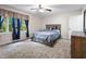 Comfortable bedroom with a queen-size bed and large window with beautiful blue curtains at 10519 N Antioch Rd, Mooresville, IN 46158