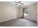Bedroom with neutral walls, plush carpeting, and natural light from the window at 10519 N Antioch Rd, Mooresville, IN 46158