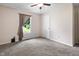 Bedroom featuring neutral walls, a ceiling fan, and a window with curtains at 10519 N Antioch Rd, Mooresville, IN 46158