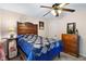 A serene bedroom showcases wooden furniture and a lovely, patterned blue bedspread at 10519 N Antioch Rd, Mooresville, IN 46158