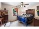 Bedroom with a patterned bedspread, a window, and a ceiling fan at 10519 N Antioch Rd, Mooresville, IN 46158