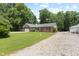 A charming brick home with a long driveway and a lush, green front yard under a blue sky at 10519 N Antioch Rd, Mooresville, IN 46158