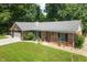 Aerial view of a brick home with a well-maintained lawn and surrounding trees at 10519 N Antioch Rd, Mooresville, IN 46158