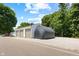 Spacious three-car garage with additional shelter on a gravel pad and mature trees at 10519 N Antioch Rd, Mooresville, IN 46158