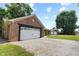 Brick home with a white garage door and a long gravel driveway at 10519 N Antioch Rd, Mooresville, IN 46158