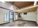Unfinished garage interior featuring a blue door, overhead lighting, and an elevated platform at 10519 N Antioch Rd, Mooresville, IN 46158