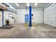 A spacious garage has a two-post lift ready for auto repair at 10519 N Antioch Rd, Mooresville, IN 46158