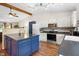 Bright kitchen with white cabinets, stainless steel appliances, and a blue island at 10519 N Antioch Rd, Mooresville, IN 46158