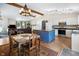 Open-concept kitchen and dining area featuring a blue island and hardwood floors at 10519 N Antioch Rd, Mooresville, IN 46158