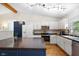 Bright kitchen featuring white cabinets, stainless steel appliances, and a dark blue island at 10519 N Antioch Rd, Mooresville, IN 46158